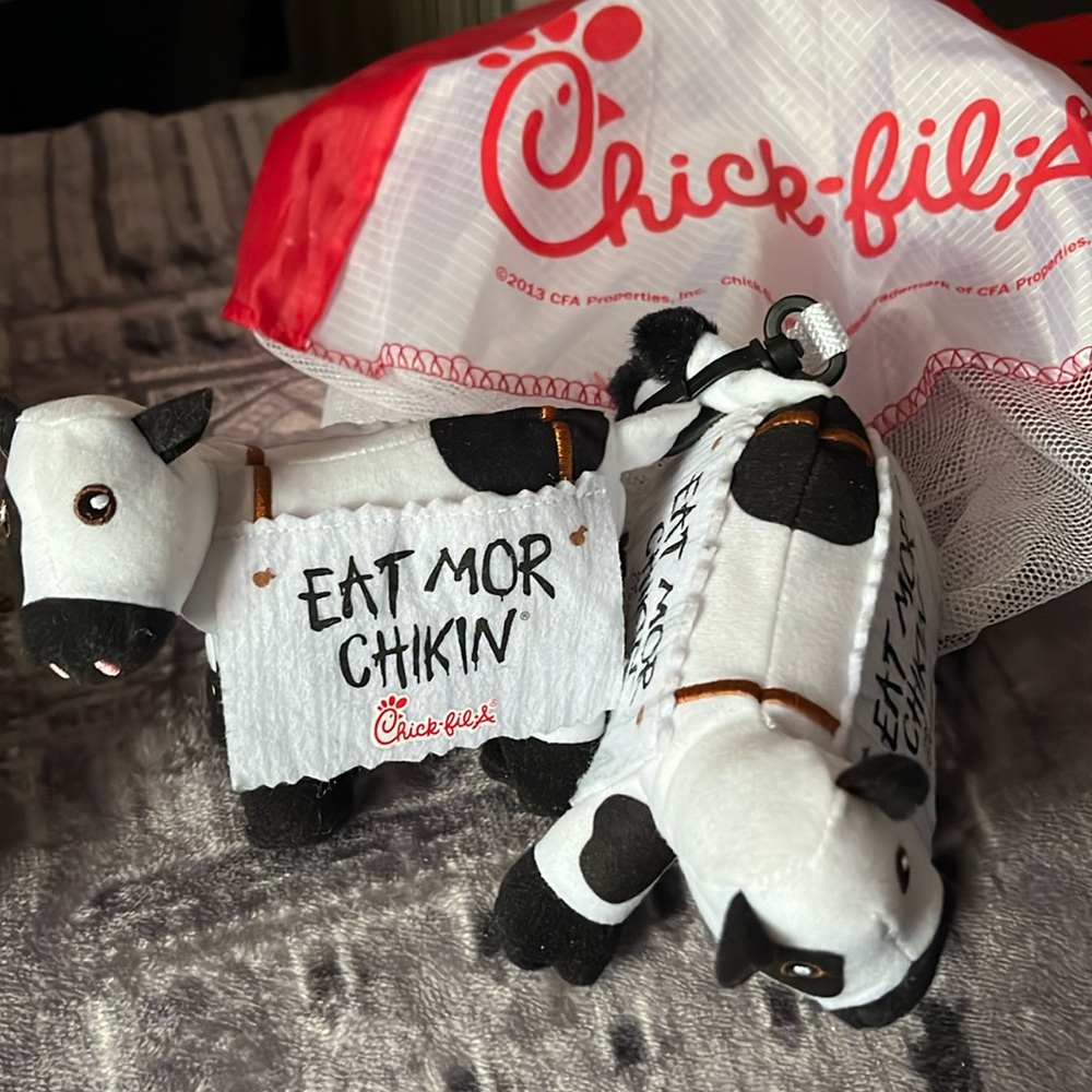 Two Chick Fil A plush cows and net hanging decor